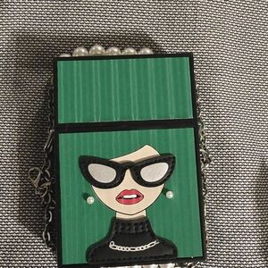 Chic Green and Black Clutch with Fashion Illustration